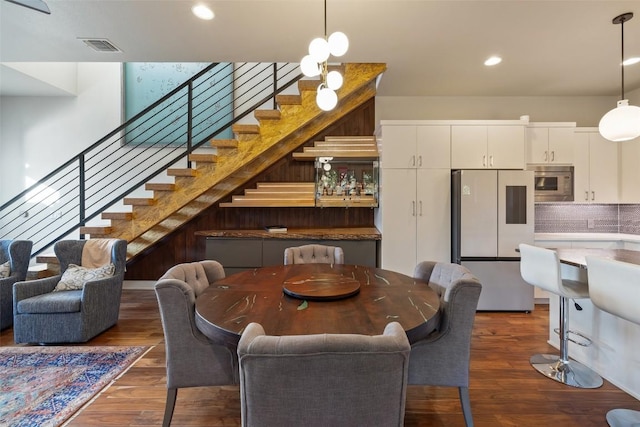 dining area featuring stairway, wood finished floors, and recessed lighting