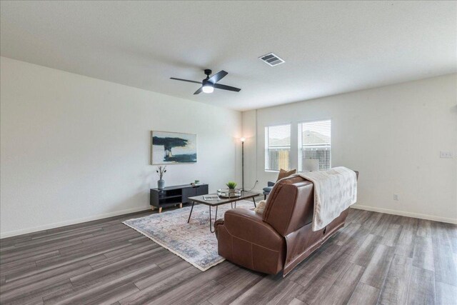 196 Thistle Ln, Maxwell, TX 78656 - living room featuring wood finished floors, ceiling fan, and baseboards