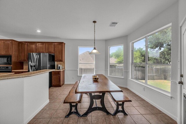 1107 Shiloh St, Cedar Park, TX 78613 - kitchen featuring black appliances, plenty of natural light, pendant lighting, light countertops, and recessed lighting