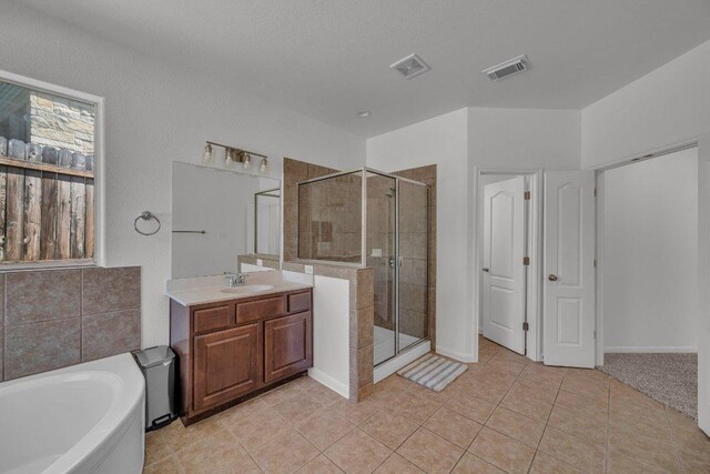 1107 Shiloh St, Cedar Park, TX 78613 - full bath featuring a shower stall, vanity, a garden tub, and tile patterned floors