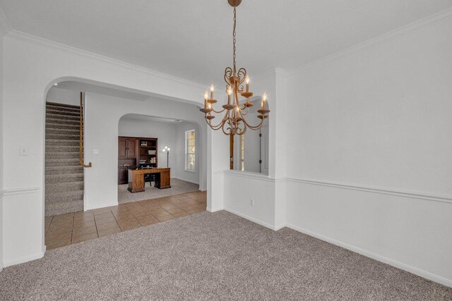 1107 Shiloh St, Cedar Park, TX 78613 - unfurnished dining area with arched walkways, carpet flooring, ornamental molding, stairway, and a chandelier