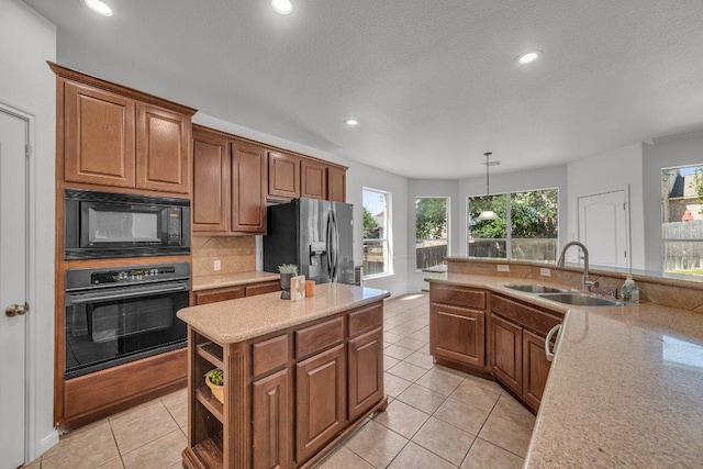 1107 Shiloh St, Cedar Park, TX 78613 - kitchen with black appliances, a sink, light tile patterned floors, light countertops, and recessed lighting