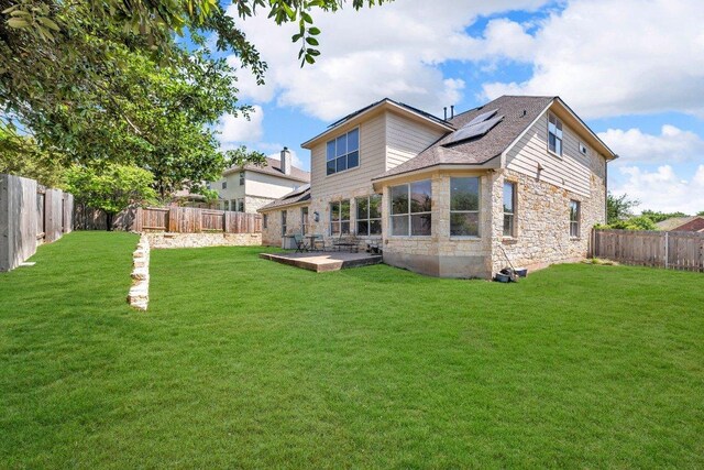 1107 Shiloh St, Cedar Park, TX 78613 - back of property featuring stone siding and solar panels