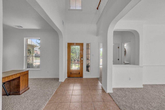 1107 Shiloh St, Cedar Park, TX 78613 - entryway featuring light carpet, baseboards, light tile patterned floors, and crown molding