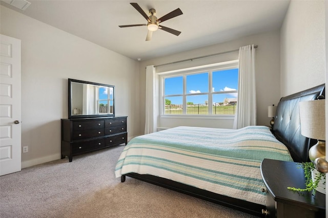 bedroom with carpet floors, a ceiling fan, and baseboards