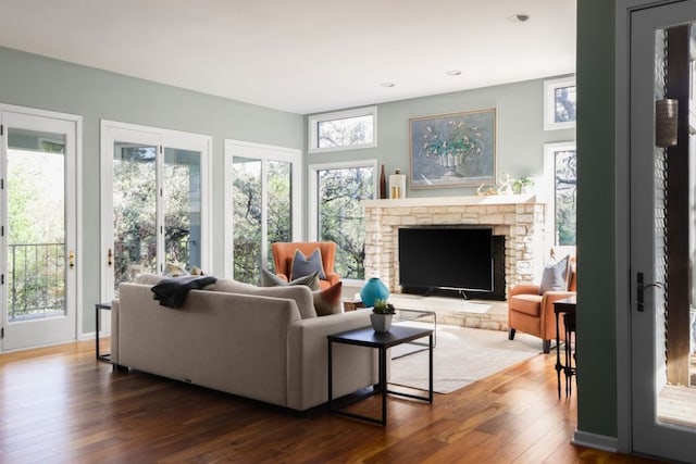 living room featuring hardwood / wood-style floors, a fireplace, and recessed lighting