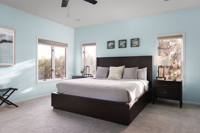 carpeted bedroom featuring baseboards and a ceiling fan
