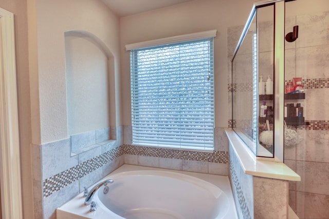 5917 Moriano Cv, Round Rock, TX 78665 - bathroom with a garden tub and tiled shower