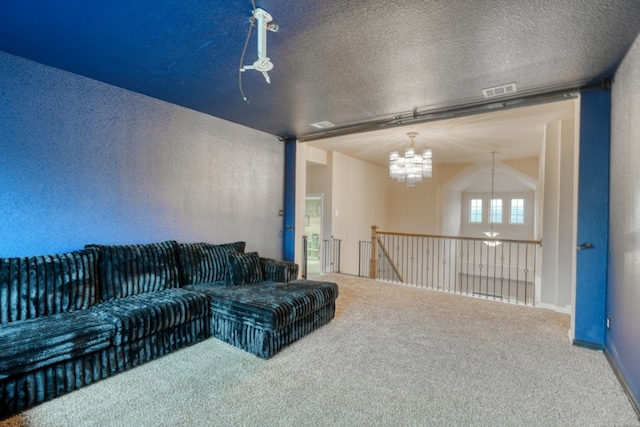 5917 Moriano Cv, Round Rock, TX 78665 - carpeted living room featuring a chandelier, a textured ceiling, and a textured wall
