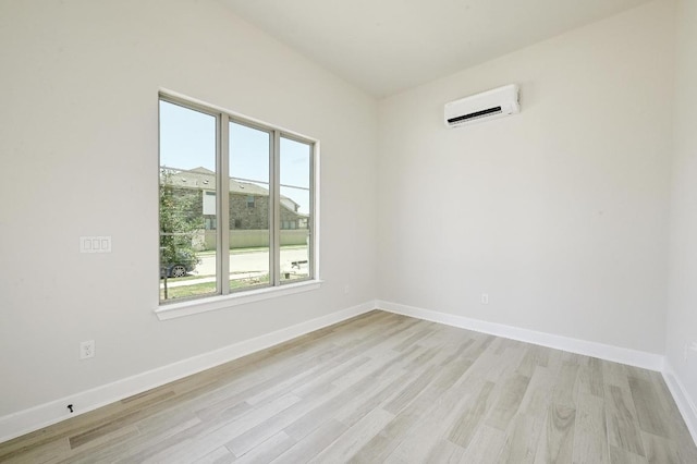 300 Echo Pass, Liberty Hill, TX 78642 - empty room featuring an AC wall unit, plenty of natural light, and light wood-style floors