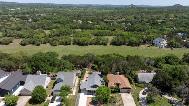 drone / aerial view featuring a view of trees and a residential view