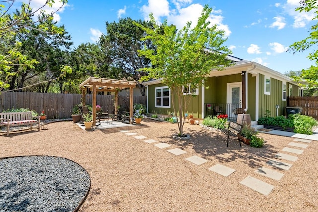 rear view of property featuring a pergola, a patio, a fenced backyard, and board and batten siding