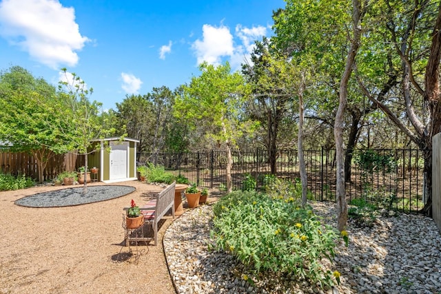 view of yard with an outbuilding, a fenced backyard, and a storage unit