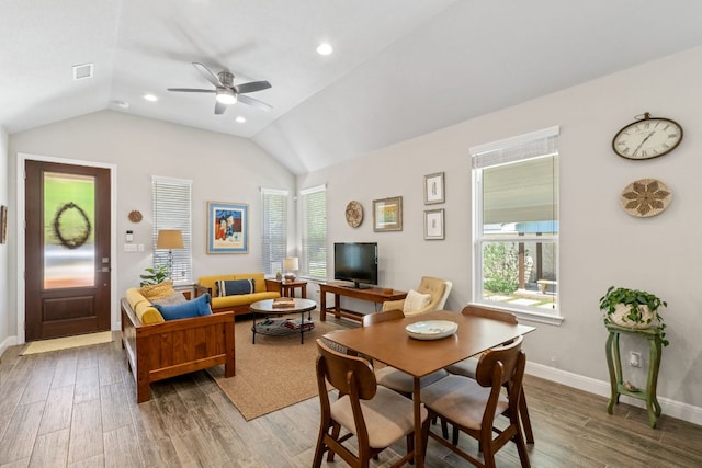 living room with ceiling fan, visible vents, wood finished floors, lofted ceiling, and baseboards