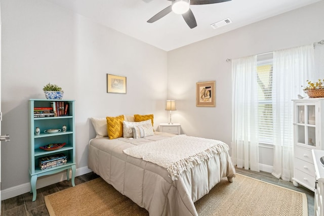 bedroom with visible vents, baseboards, a ceiling fan, and wood finished floors