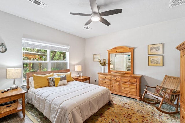 bedroom featuring visible vents, a ceiling fan, and wood finished floors
