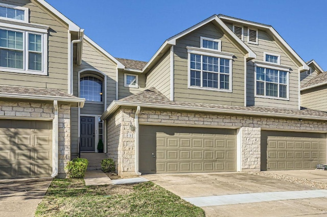 2632 Century Park Blvd Unit 3, Austin, TX 78727 - view of property with an attached garage, driveway, stone siding, and a shingled roof