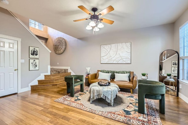 2632 Century Park Blvd Unit 3, Austin, TX 78727 - living room featuring wood finished floors, ceiling fan, baseboards, and stairs