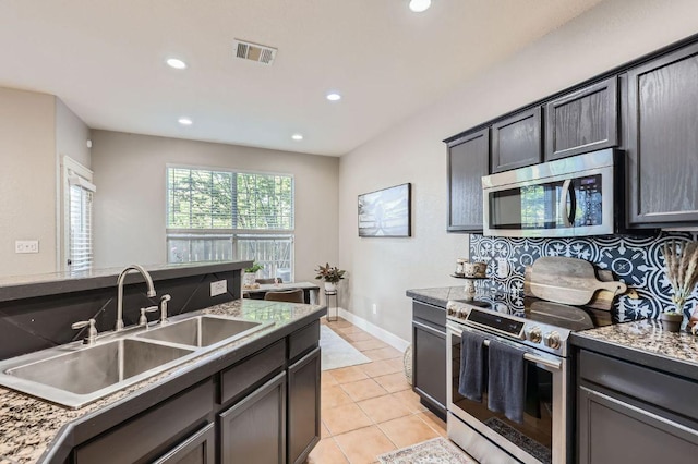 2632 Century Park Blvd Unit 3, Austin, TX 78727 - kitchen featuring visible vents, recessed lighting, light tile patterned flooring, a sink, and stainless steel appliances
