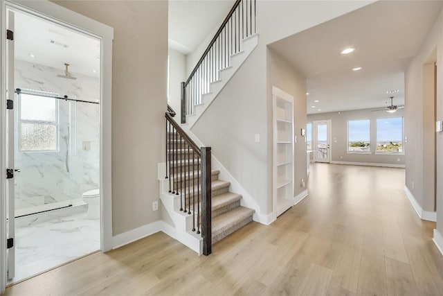 508 Saturnia Cv, Georgetown, TX 78628 - stairs with wood finished floors, recessed lighting, baseboards, and ceiling fan