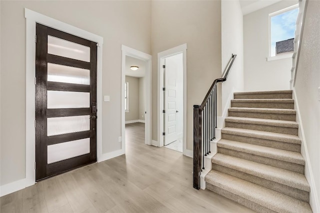 508 Saturnia Cv, Georgetown, TX 78628 - foyer entrance with wood finished floors, stairway, and baseboards