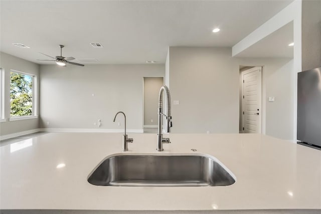 508 Saturnia Cv, Georgetown, TX 78628 - kitchen featuring a sink, light countertops, open floor plan, a ceiling fan, and recessed lighting