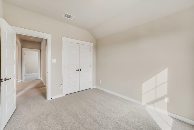 508 Saturnia Cv, Georgetown, TX 78628 - unfurnished bedroom with light colored carpet, baseboards, a closet, and lofted ceiling
