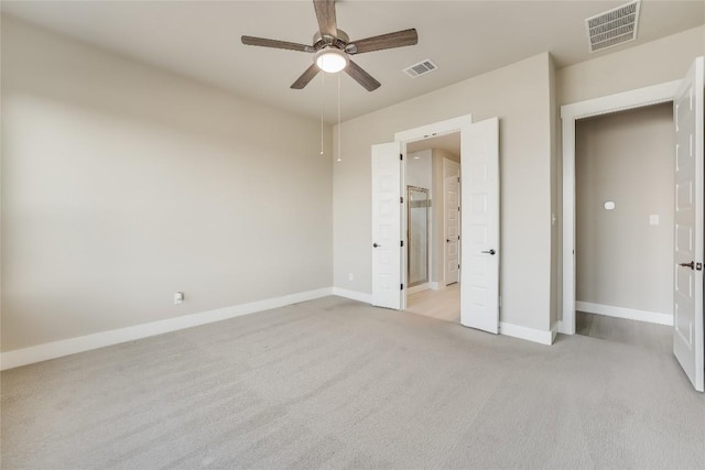 508 Saturnia Cv, Georgetown, TX 78628 - unfurnished bedroom with light colored carpet, baseboards, a ceiling fan, and connected bathroom