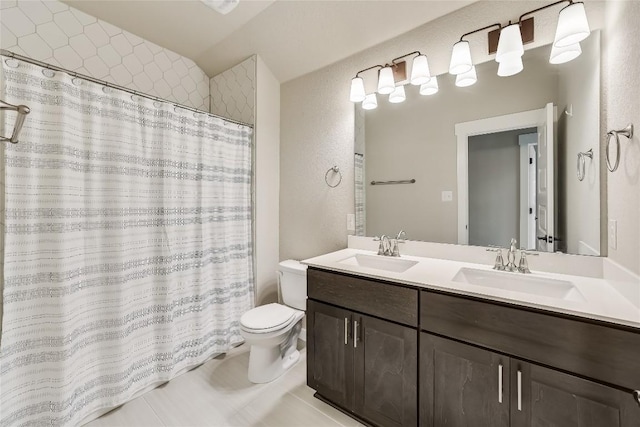 508 Saturnia Cv, Georgetown, TX 78628 - bathroom with toilet, double vanity, tile patterned flooring, curtained shower, and a textured wall