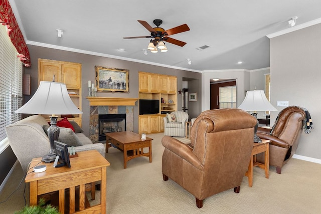108 Chuckwagon Trl, Georgetown, TX 78633 - living room with a ceiling fan, light carpet, a tiled fireplace, and ornamental molding