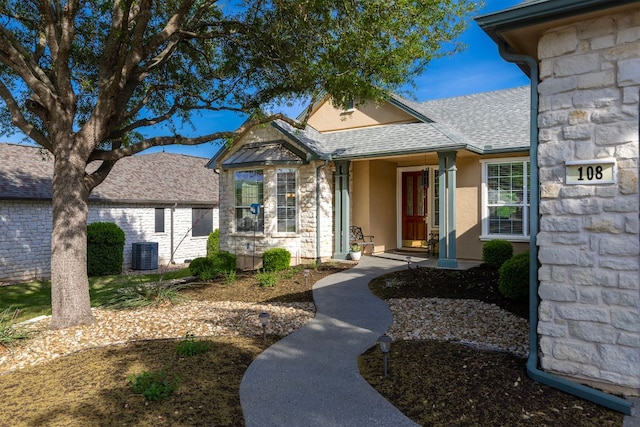 108 Chuckwagon Trl, Georgetown, TX 78633 - doorway to property featuring stucco siding, stone siding, and roof with shingles
