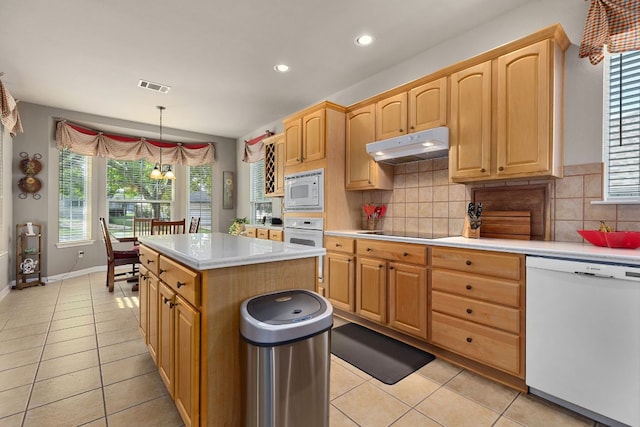 108 Chuckwagon Trl, Georgetown, TX 78633 - kitchen featuring white appliances, under cabinet range hood, light tile patterned floors, light countertops, and recessed lighting