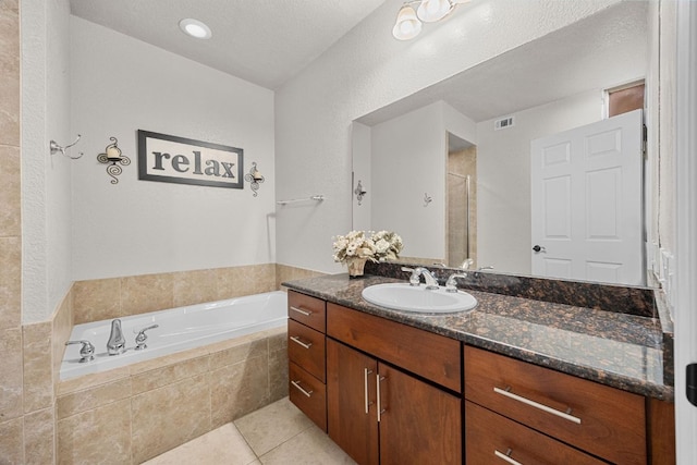 full bath with visible vents, a bath, vanity, tile patterned flooring, and a stall shower