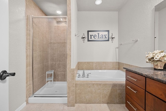 full bath with tile patterned flooring, a bath, a stall shower, and a textured wall
