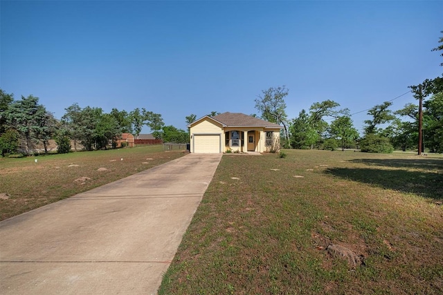 view of front of house featuring an attached garage, driveway, and a front lawn