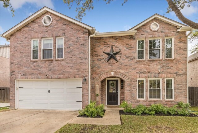 view of front of house with brick siding, concrete driveway, an attached garage, and a front yard