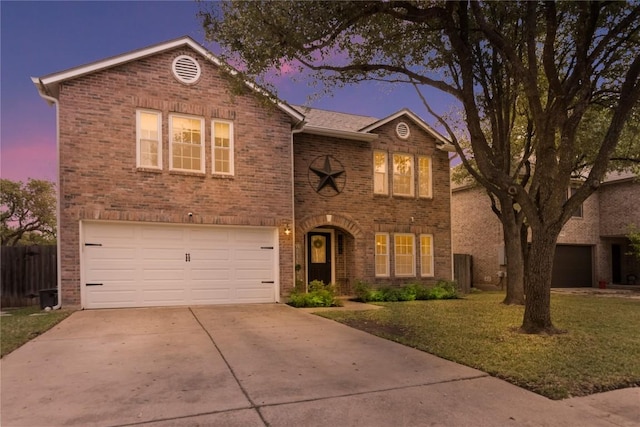 traditional-style home featuring a garage, brick siding, and driveway