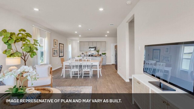 395 Morning Glory Loop, Kyle, TX 78640 - dining area with light wood-style floors, baseboards, and recessed lighting