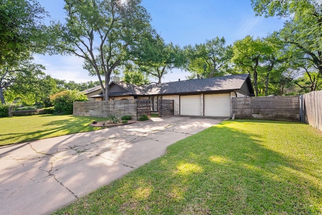5911 W Gate Blvd, Austin, TX 78745 - view of front facade featuring a garage, concrete driveway, and stone siding