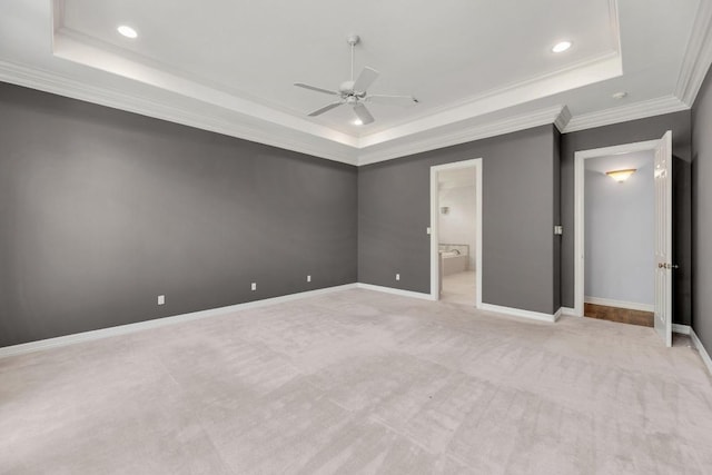 unfurnished bedroom featuring crown molding, a tray ceiling, baseboards, and recessed lighting