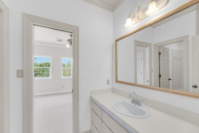 bathroom with crown molding, vanity, baseboards, and visible vents