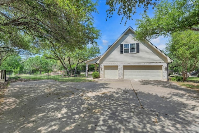 exterior space with a garage, driveway, and fence