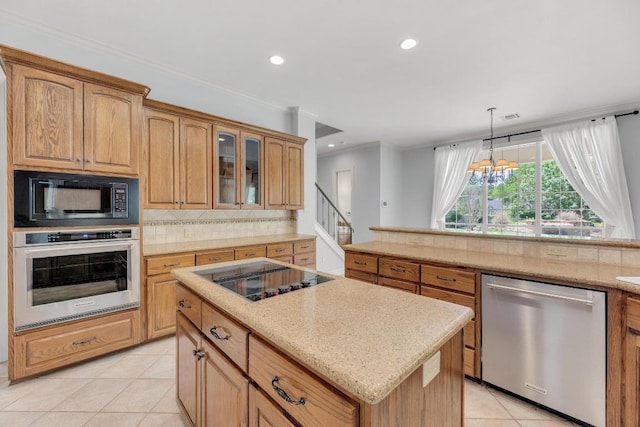 kitchen featuring tasteful backsplash, light tile patterned floors, a center island, black appliances, and recessed lighting
