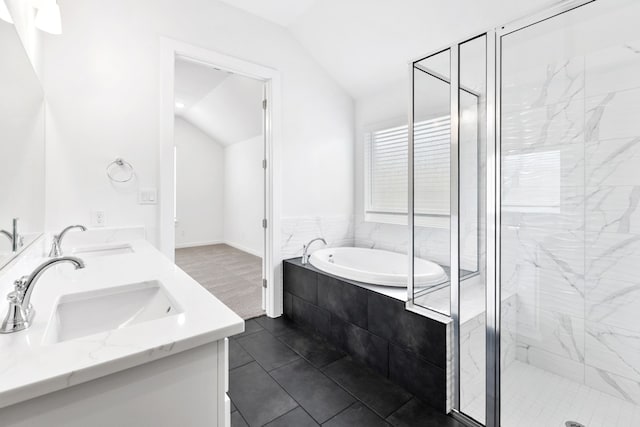220 Washington Dr, Kyle, TX 78640 - bathroom with vaulted ceiling, a bath, a shower stall, and double vanity