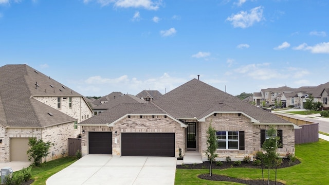 220 Washington Dr, Kyle, TX 78640 - french country inspired facade with roof with shingles, a garage, driveway, brick siding, and a residential view