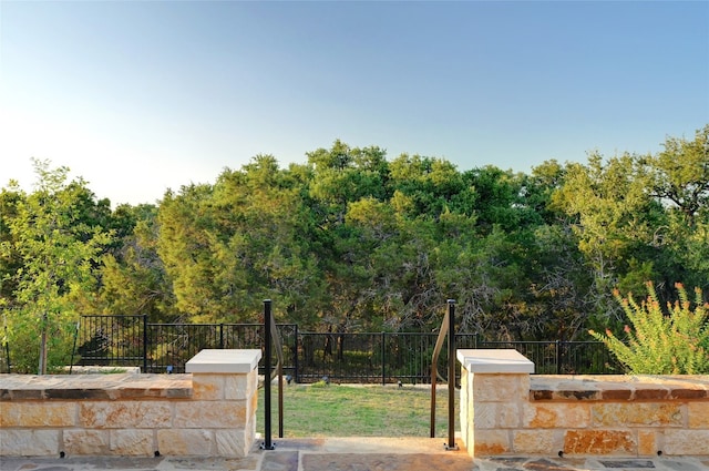 262 Singing Sumac Way, San Marcos, TX 78666 - gate featuring a forest view