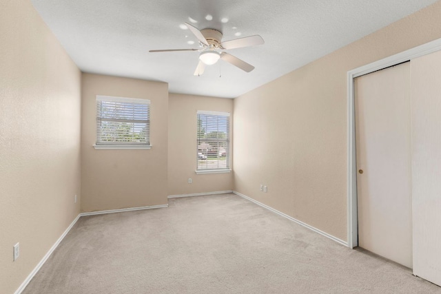 141 Sydneys Way, Buda, TX 78610 - unfurnished bedroom with carpet flooring, a ceiling fan, and a closet