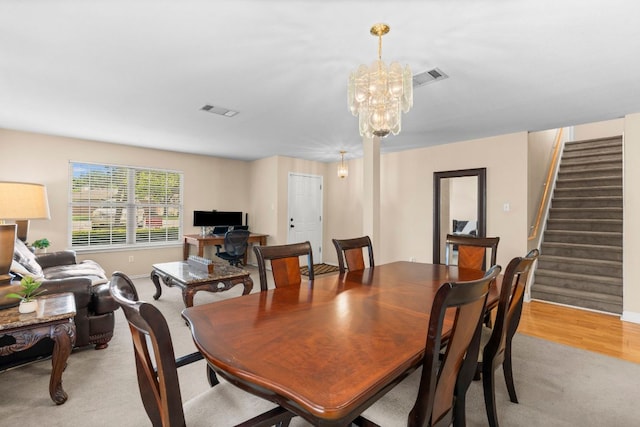 141 Sydneys Way, Buda, TX 78610 - dining space with stairway, light carpet, and a chandelier