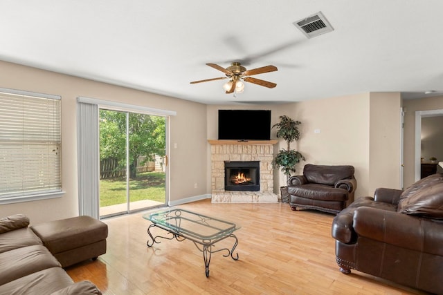 141 Sydneys Way, Buda, TX 78610 - living area featuring a ceiling fan, wood finished floors, and a fireplace