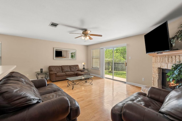 141 Sydneys Way, Buda, TX 78610 - living area featuring ceiling fan, wood finished floors, and a glass covered fireplace